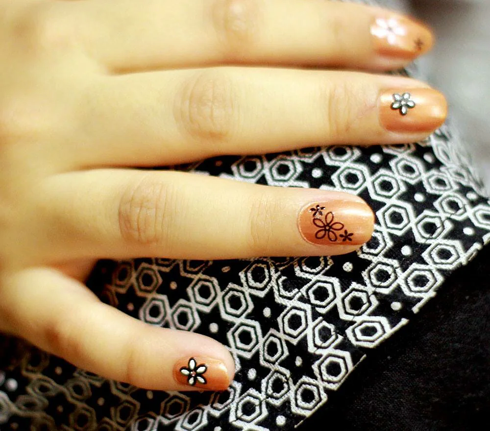 Floral nail art on nude polish